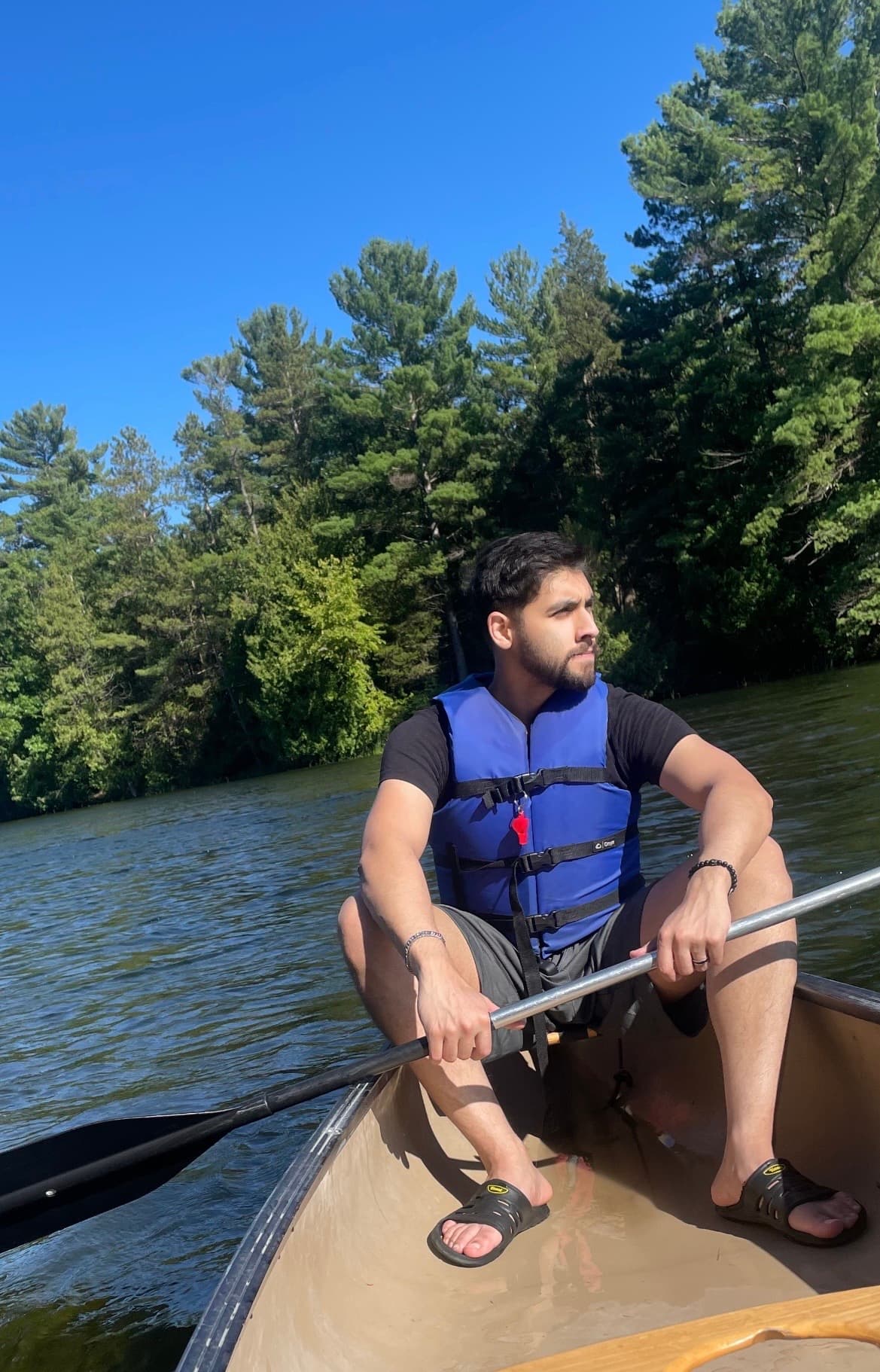Sami Qureshi canoeing on a lake