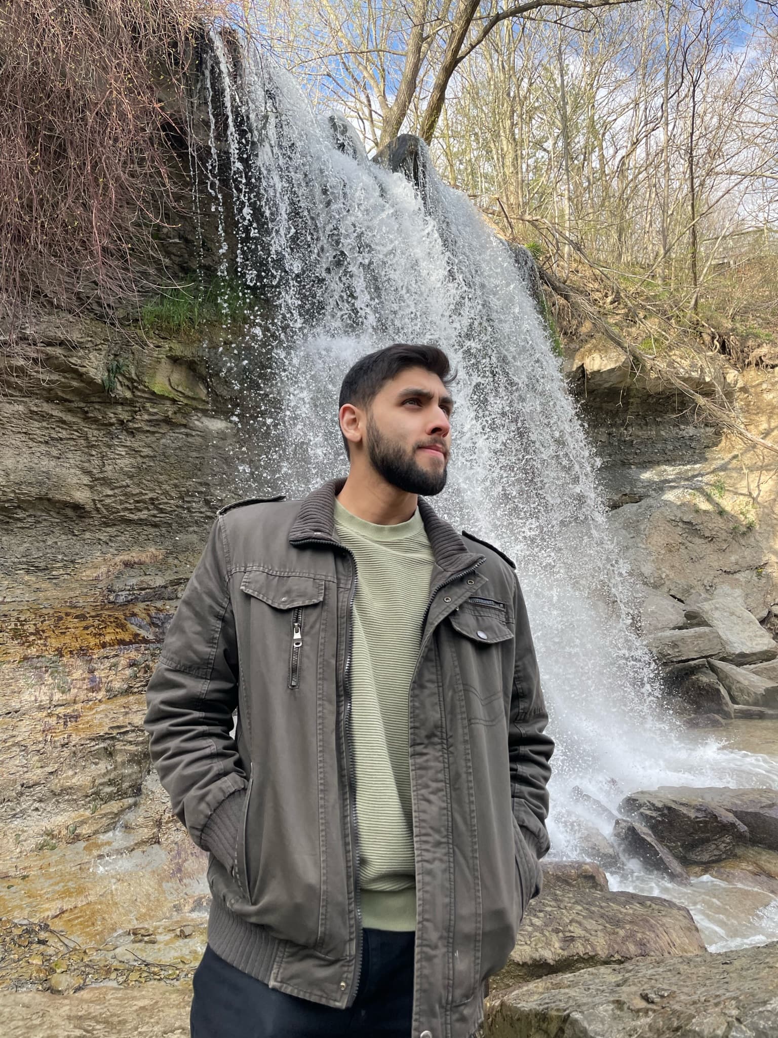 Sami Qureshi outdoors by a waterfall
